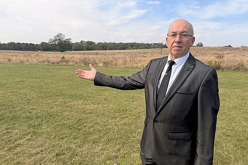 Brian Barrett gestures towards the open land beside Weelsby Woods identified for a proposed development of up to 1,500 homes.